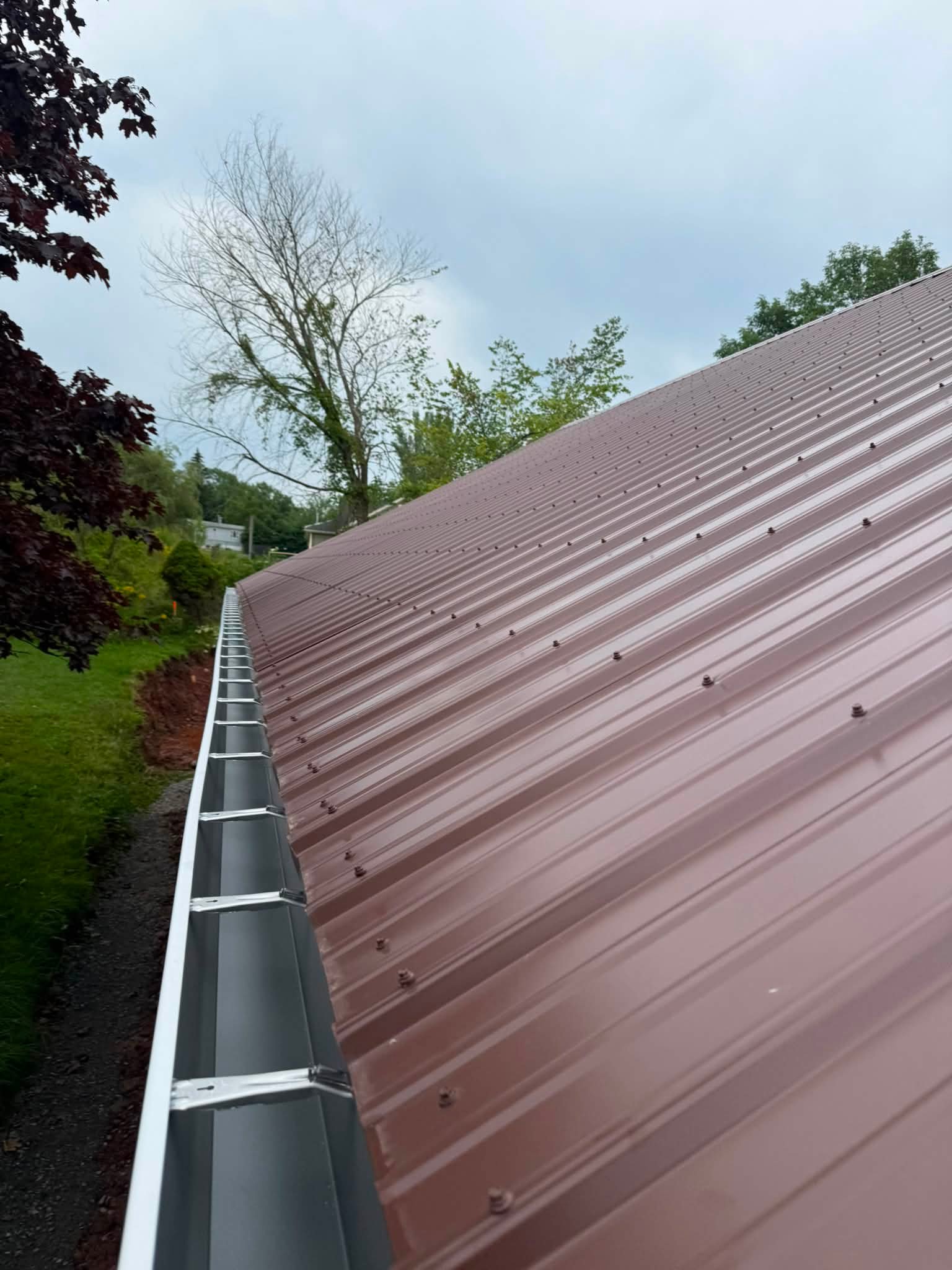 Close view along a metal roof and eavestrough