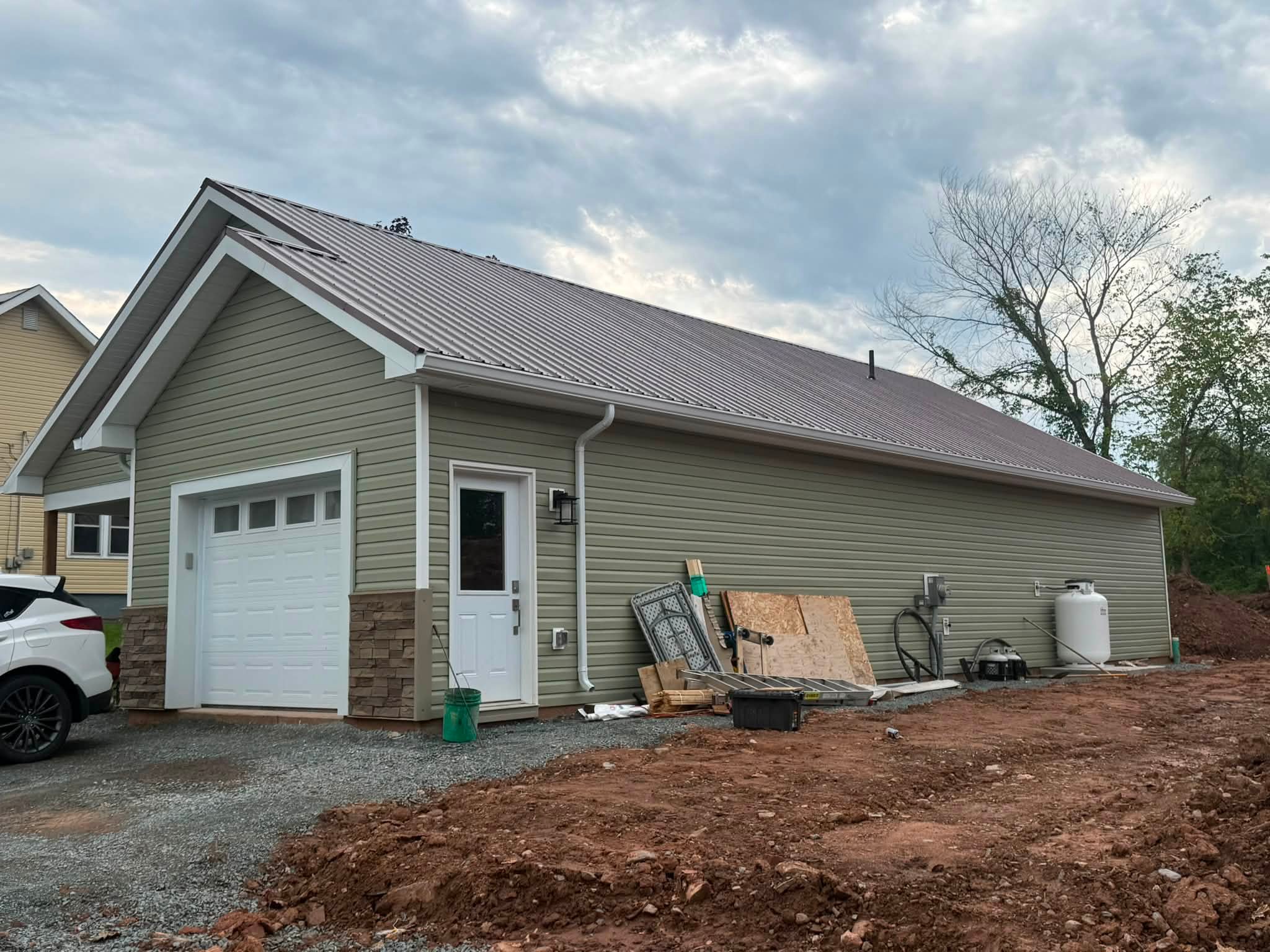 New downspout routed along a home exterior